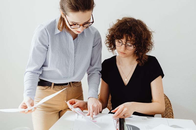 Person reviewing documents at a laptop while completing an online loan application